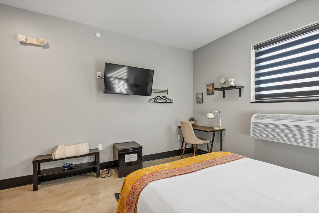 Desk in room along with tv