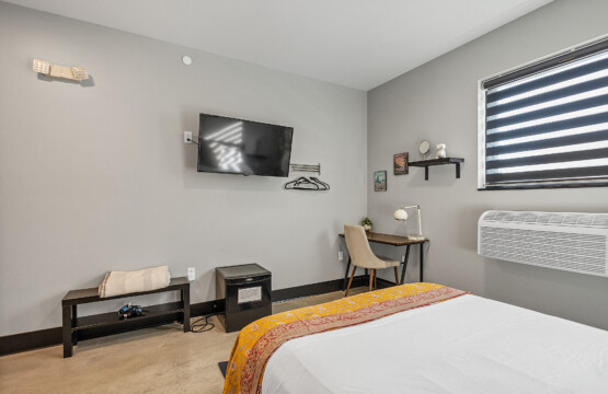 Desk in room along with tv