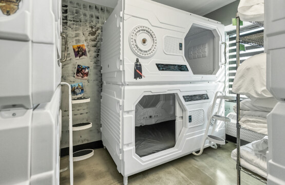 Second floor sleeping pod room for 8 with a full bathroom