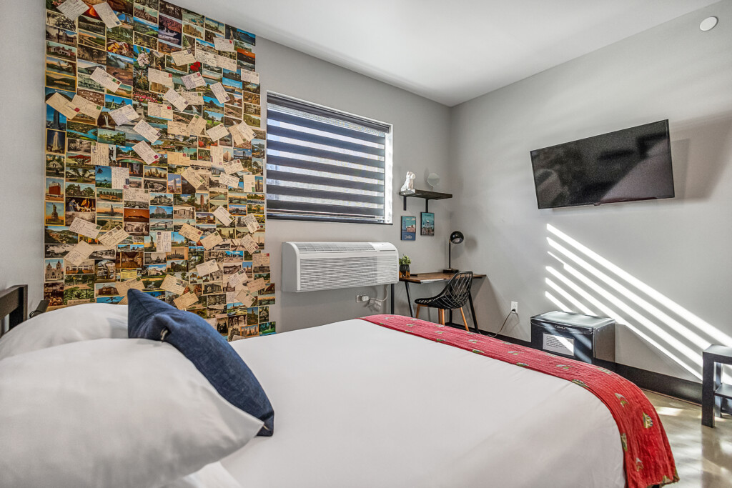 Queen room on second floor with half bathroom in room and 2 available shower rooms