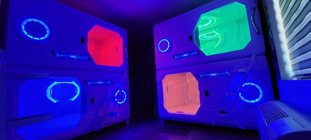 8 sleeping pods with lights and fan inside