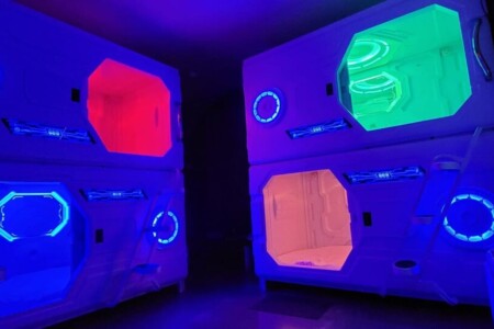 8 sleeping pods with lights and fan inside